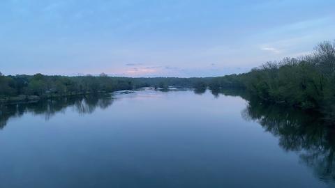 A calm photo of a river at dusk