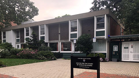 1960s Brutalist style two-story building and main gate to the interior courtyard