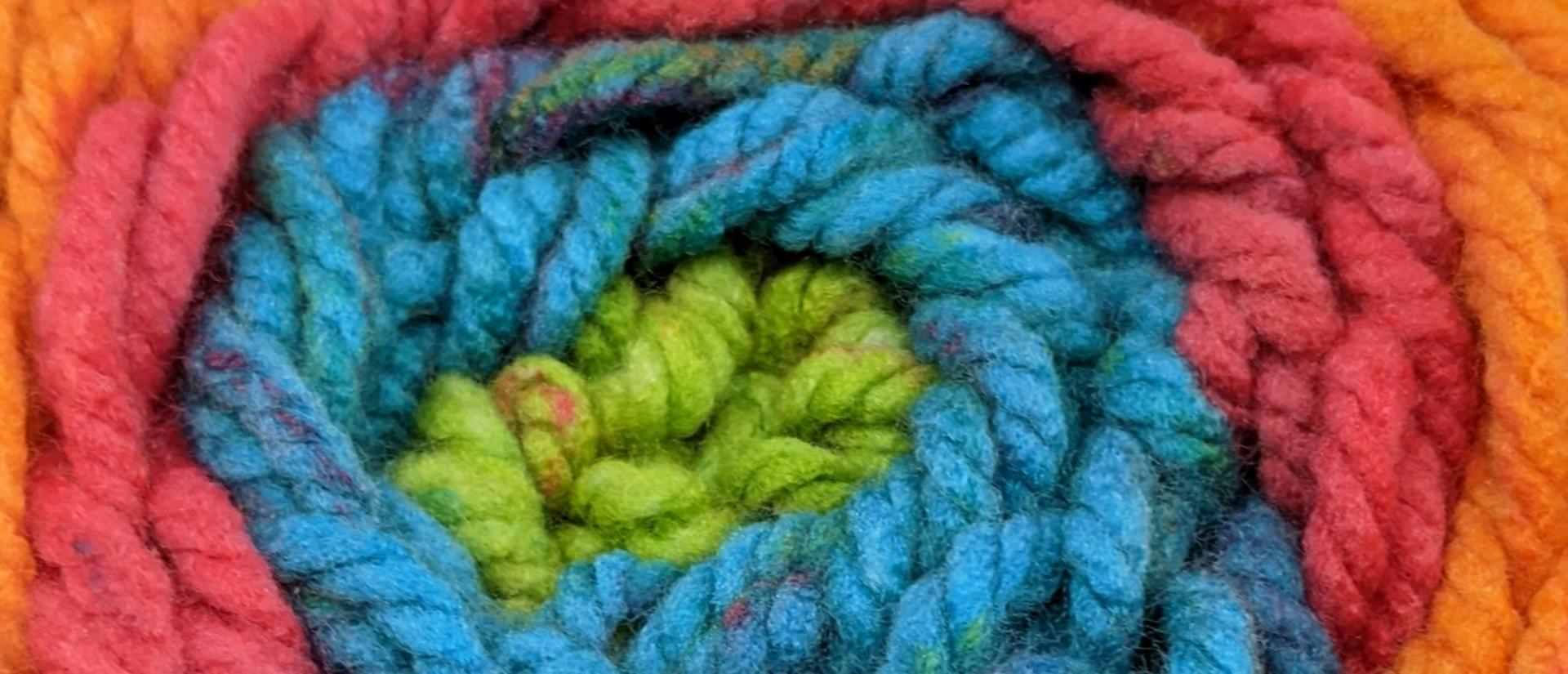 A rolled ball of rainbow yarn